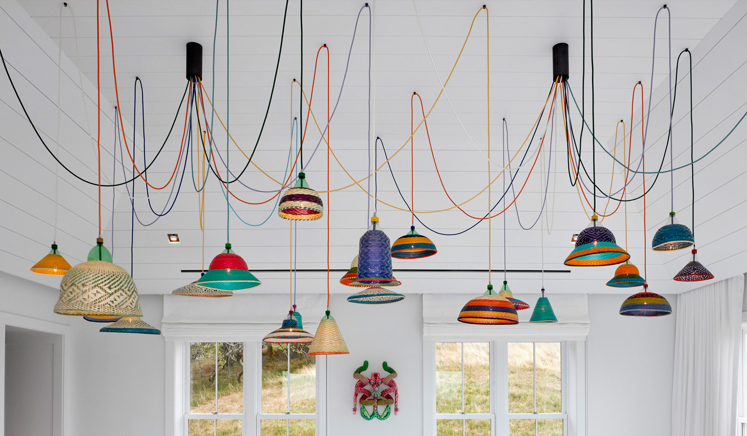PET Lamp installation suspended over a dining space